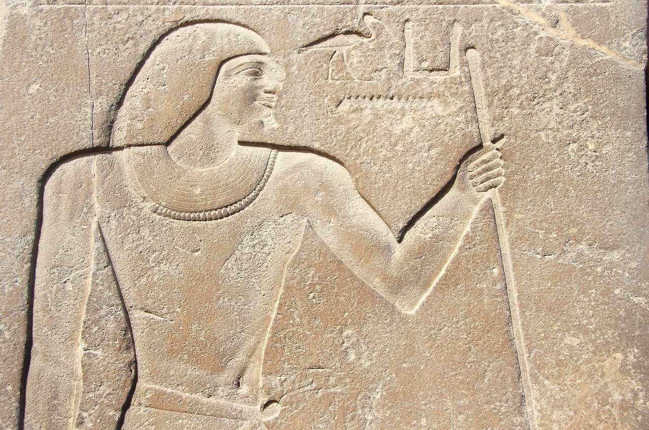 Ancient Saqqara Tomb with a man having a stick and crane in Egypt