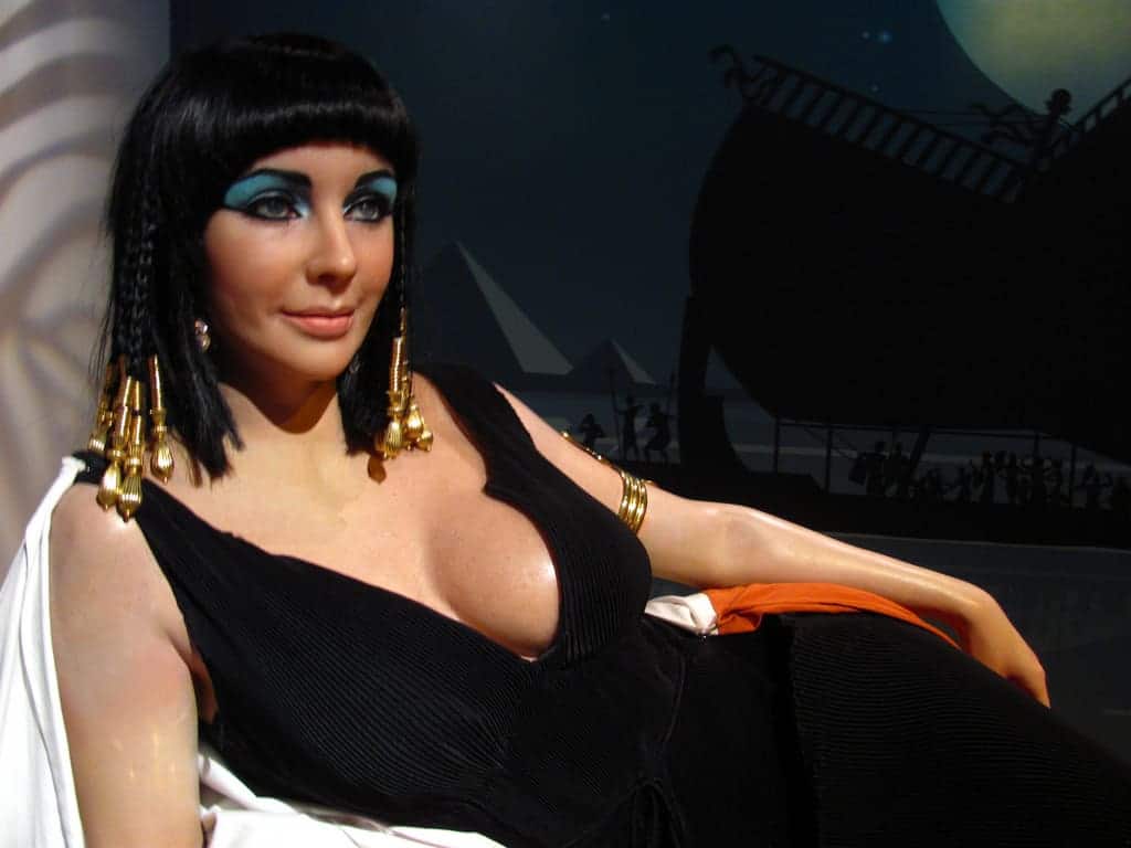 A wax figure of a woman in Egyptian attire reclines, hinting at Nile cruise films scenery.