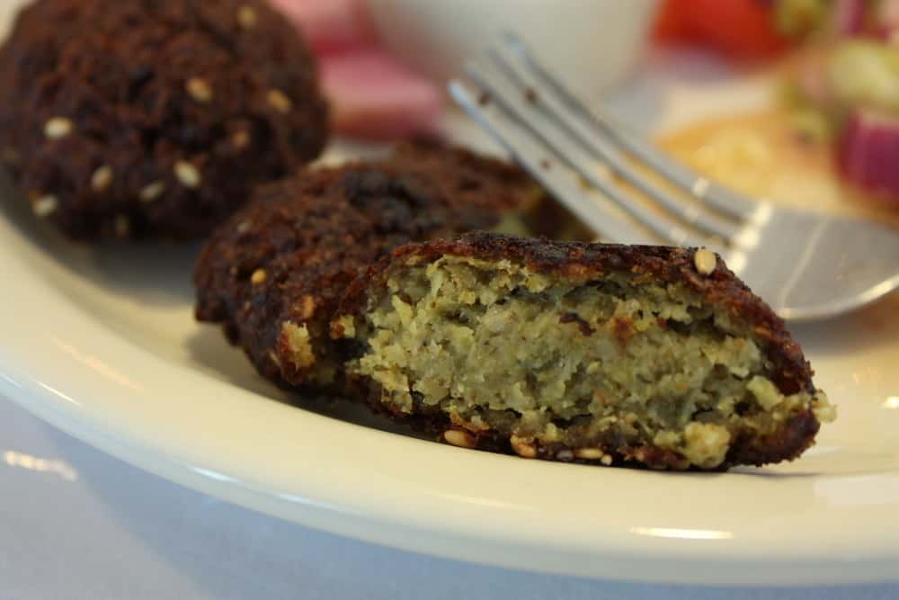 Nile cruise essential: Close-up of halved falafel on a plate with a fork.