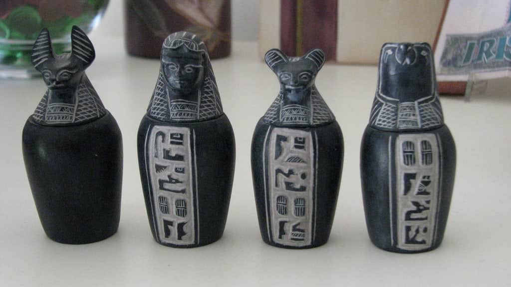 Four Egyptian canopic jars with animal-headed lids, perfect Nile cruise souvenirs.