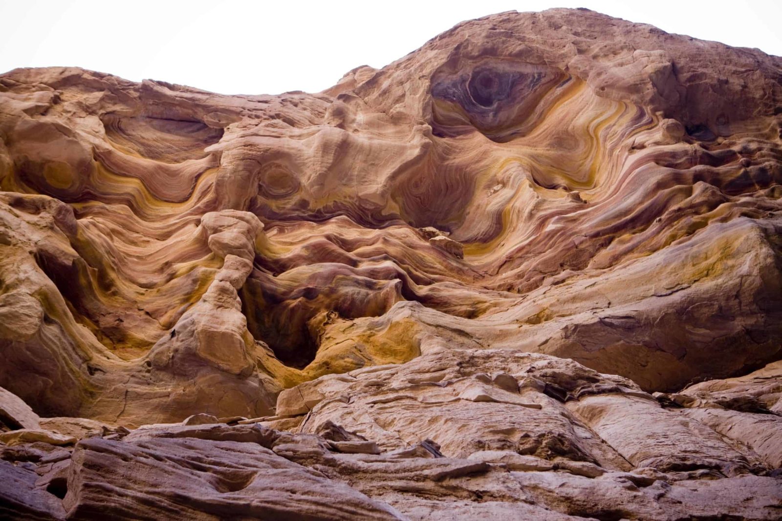 Why visit the Coloured Canyon? Colorful sandstone rocks swirl with patterns and textures.