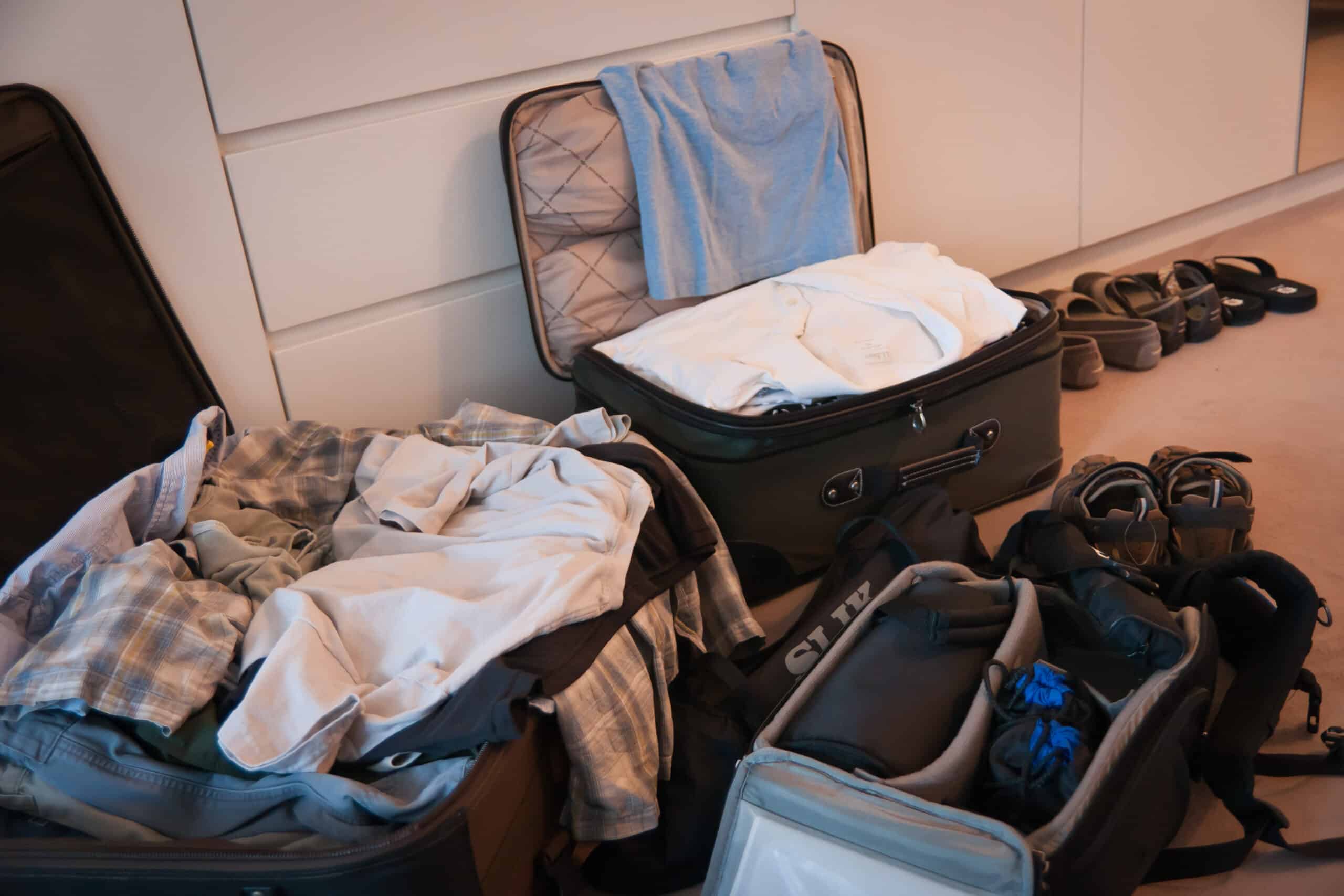 Open suitcases with clothes and shoes, ready for the Egypt holiday.