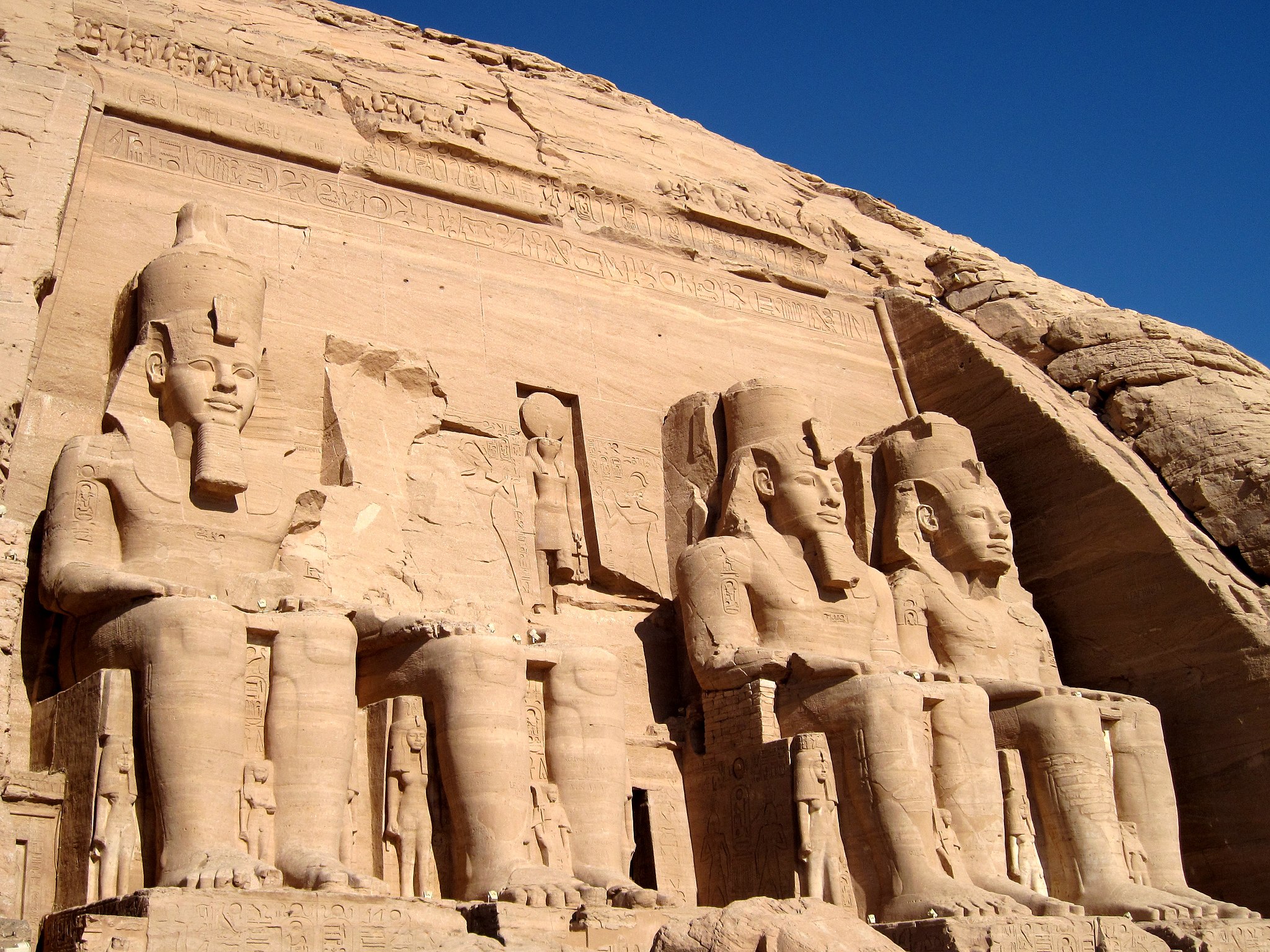 Huge stone statues at Abu Simbels entrance, a must-see on a Nile cruise under Egypts clear blue sky.
