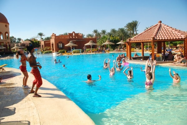 Guests at Nubian Island Hotel enjoy an aqua aerobics class in the resorts pool area.