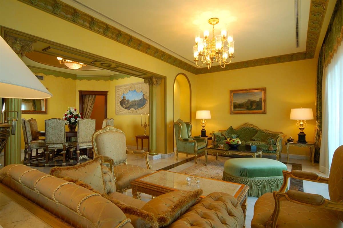 Luxurious living room at Concorde EL Salam with ornate furniture and elegant dining area.