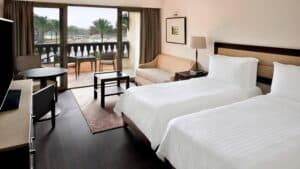 Marriott Mena House room: two beds, sofa, table, and a balcony view.