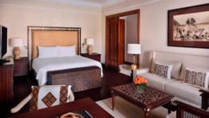 Elegant Marriott Mena House room with bed, sofa, and coffee table.
