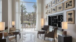 Marriott Mena House lounge: bright space with chairs, tables, large window, and framed photos.