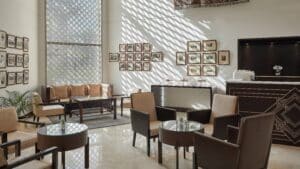 Bright, modern lounge area with seating, framed photos, and a Marriott Mena House vibe.