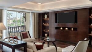 Modern living room at Marriott Mena House with a flat-screen TV, seating, and decor items.