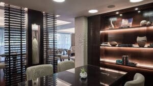 Modern office lounge with bookshelves, Marriott Mena House decor, and a black table with chairs.