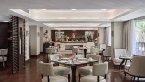 Elegant restaurant at Marriott Mena House with white chairs and a buffet area in the background.