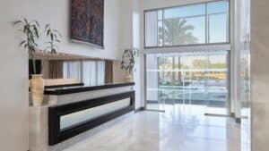 Marriott Mena House lobby: modern design, large windows, lush decorative plants.