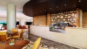 Sheraton Cairo Hotels modern lounge offers seating, a counter with food and drinks, and geometric decor.