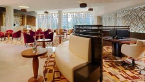 Sheraton Cairo Hotel & Casino lobby with modern furniture, red chairs, and patterned carpet.