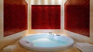 Spa room with circular jacuzzi and red mosaic tiles at Sheraton Cairo Hotel & Casino.