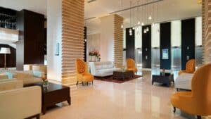 Sheraton Cairo Hotel lobby with chic seating, decorative walls, and sleek elevator doors.