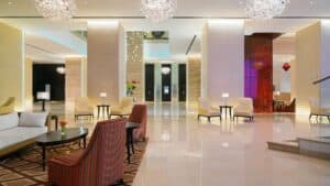 Sheraton Cairo Hotel & Casino lobby: modern with seating, tables, and hanging lights.