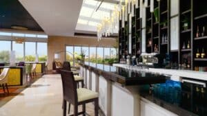 Sheraton Cairos bar boasts a modern interior with high chairs, bottle shelves, and hanging lights.
