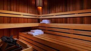 Sheraton Cairo Hotel & Casino sauna with wooden interior and warm light, towels stacked neatly.