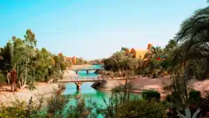 A serene canal with pedestrian bridges by colorful buildings near Sheraton Miramar Resort.