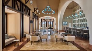 Sheraton Miramars modern lounge features blue chandeliers and high arched ceilings.