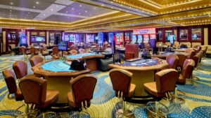 Empty casino at Sheraton Cairo with gaming tables and slots under bright ceiling lights.