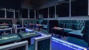 Chic nightclub in Sheraton Cairo with plush seating, sleek tables, and dim lighting.