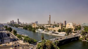 Aerial view of a cityscape with a river, bridges, and the Sheraton Cairo Hotel & Casino.