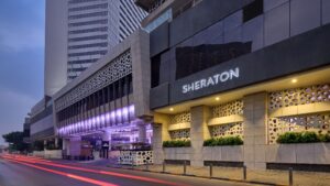 Exterior of Sheraton Cairo Hotel & Casino with a modern design and decorative facade elements.