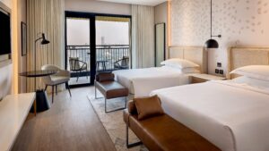 Sheraton Cairo Hotel & Casino room with two beds, a balcony view, and modern decor.
