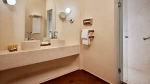 Sheraton Miramar Resort bathroom: dual sinks, mirrors, towels, and a walk-in shower.
