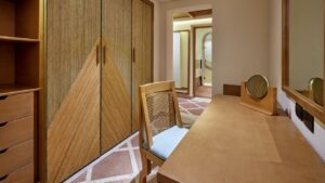 Wooden desk and chair in a room with tiled floor at Sheraton Miramar Resort.