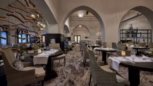 Elegant restaurant at Sheraton Miramar Resort with modern decor and a vaulted ceiling.