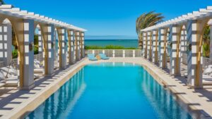 Poolside with pergola arches and ocean view at Sheraton Miramar Resort.
