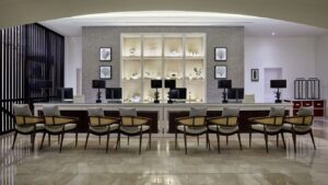 Modern Sheraton Miramar lobby with chairs and a backlit decorative wall display.