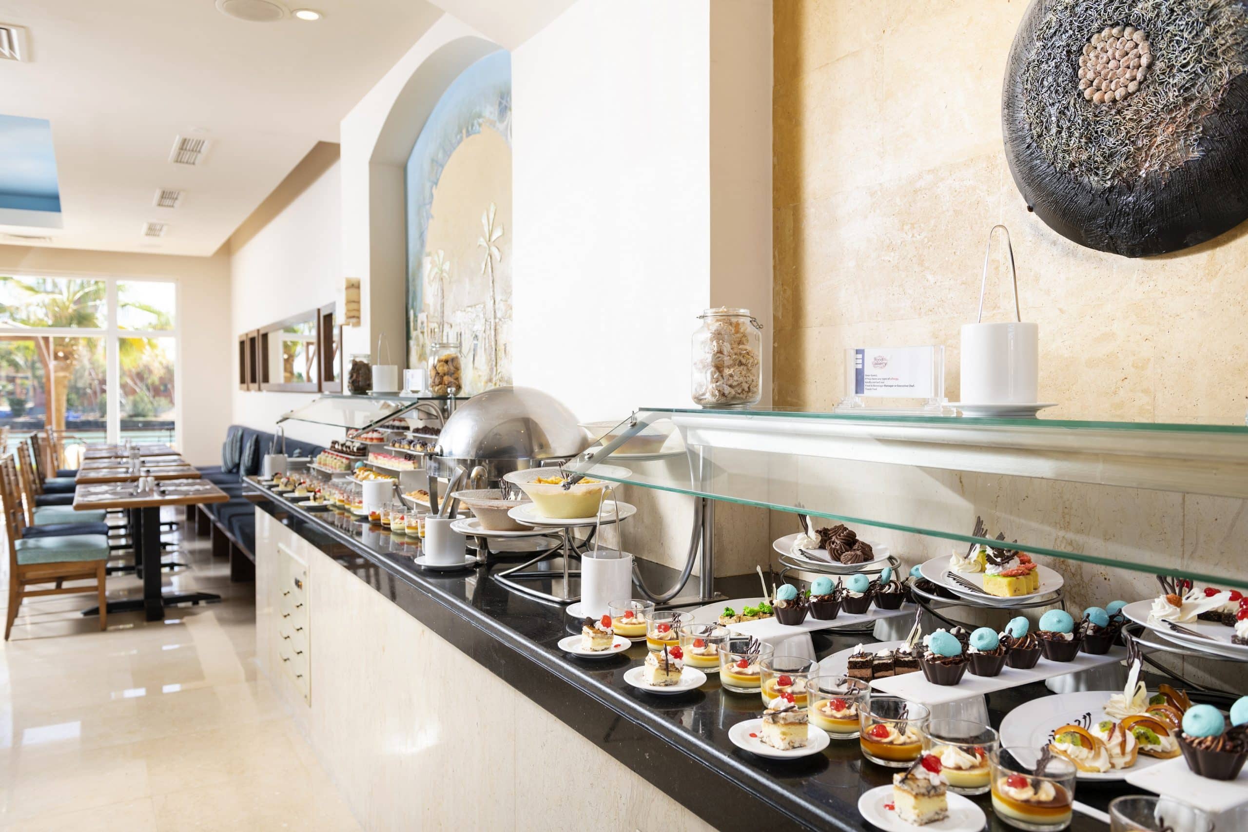 Buffet table with various desserts at Three Corners Ocean View restaurant setting.