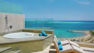 Rooftop jacuzzi at Hilton Hurghada with beach views and nearby lounge chairs.