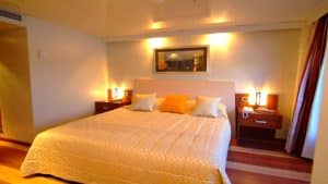 MS Classic Blue Shadow IV 5* room with a large bed, nightstands, lamps, and artwork.