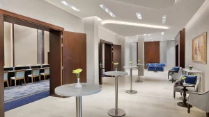 Hilton Hurghadas modern conference area with round tables, chairs, and wall artwork.