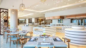 Hilton Hurghadas modern restaurant features set tables, bright lighting, and decorative elements.