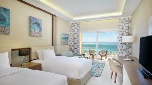 Hilton Hurghada room: two beds, TV, balcony with ocean view.