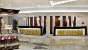 Hilton Hurghada lobby with three illuminated desks and decorative lighting.