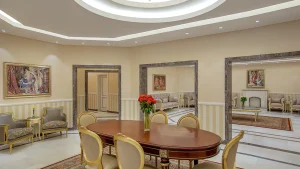 Elegant Hilton Hurghada room with a round table, chairs, armchairs, and paintings on the walls.