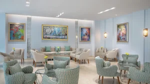 Hilton Hurghada lobby with patterned chairs, glass tables, and colorful artwork on walls.