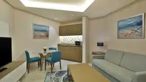 Hilton Hurghada room with a kitchenette, dining table, and seating area.
