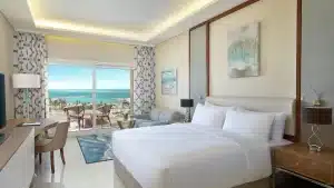 Hilton Hurghada room: ocean view, balcony, double bed, desk, and seating area.