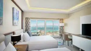 Hilton Hurghada room with twin beds, ocean view, and modern decor.