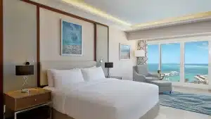 Hilton Hurghada room with a large bed, ocean view, and contemporary decor.
