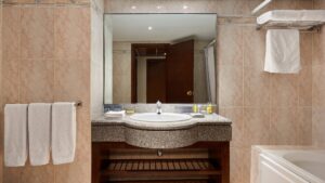Hotel bathroom at Hurghada Marriott Beach Resort with a mirror, sink, and toiletries.